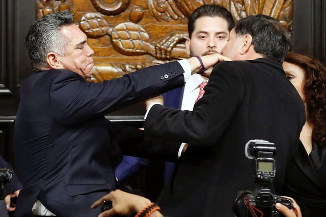 Senator Alejandro Moreno (L) throws a punch at Senator Gerardo Fernandez Norona during a session of the Permanent Commission of the Senate in Mexico City on August 27, 2025.