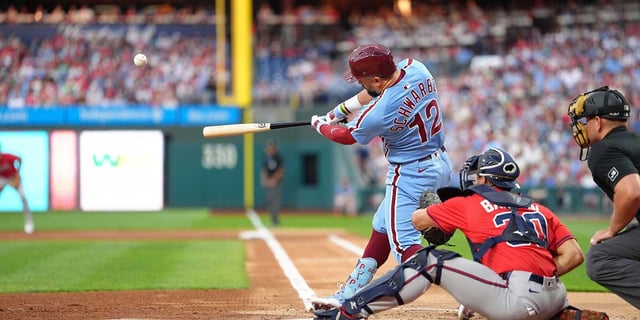 Aug 28, 2025; Philadelphia, Pennsylvania, USA; Philadelphia Phillies designated hitter Kyle Schwarber (12) hits a home run against the Atlanta Braves in the first inning at Citizens Bank Park. Mandatory Credit: Kyle Ross-Imagn Images
