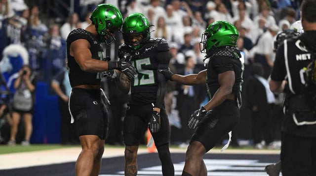 Oregon Ducks tight end Kenyon Sadiq (18), wide receiver Tez Johnson (15) and running back Noah Whittington (6) celebrate a touchdown against the Penn State Nittany Lions during the third quarter in the 2024 Big Ten Championship game at Lucas Oil Stadium. Mandatory Credit: Robert Goddin-Imagn Images