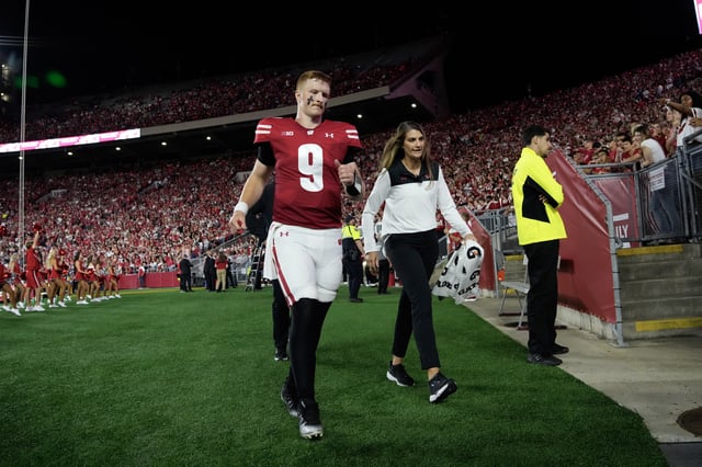 Aug 28, 2025; Madison, Wisconsin, USA;  Wisconsin Badgers quarterback Billy Edwards Jr. (9) walks to the locker room after being injured during the second quarter against the Miami (OH) RedHawks at Camp Randall Stadium. Mandatory Credit: Jeff Hanisch-Imagn Images