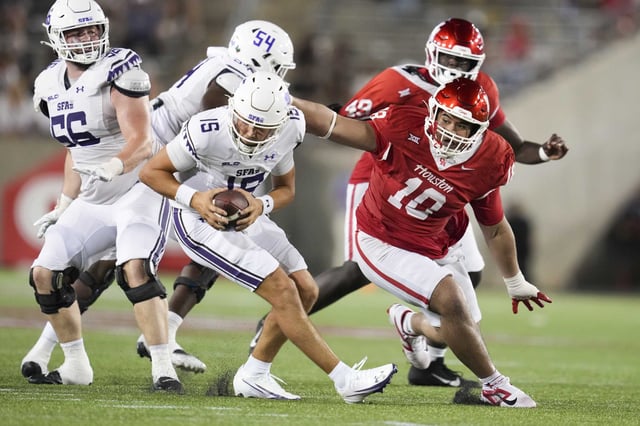 Houston Cougars defensive lineman Khalil Laufau (18) forces a fumble against Stephen F. Austin quarterback Sam Vidlak (15) during the second half of a NCAA college football game at TDECU Stadium in Houston, Thursday, Aug. 28, 2025.