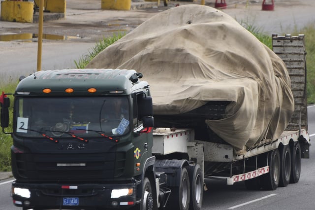 Trucks transport tanks east from Valencia, Venezuela, Wednesday, Aug. 27, 2025, after the government announced a military mobilization following the U.S. deployment of warships off Venezuela. (AP Photo/Jacinto Oliveros)