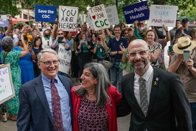 Former Centers for Disease Control (CDC) officials Dan Jernigan, Deb Houry, and Demetre Daskalakis smile as employees and supporters of the CDC line up outside its global headquarters on August 28, 2025 in Atlanta, Georgia.