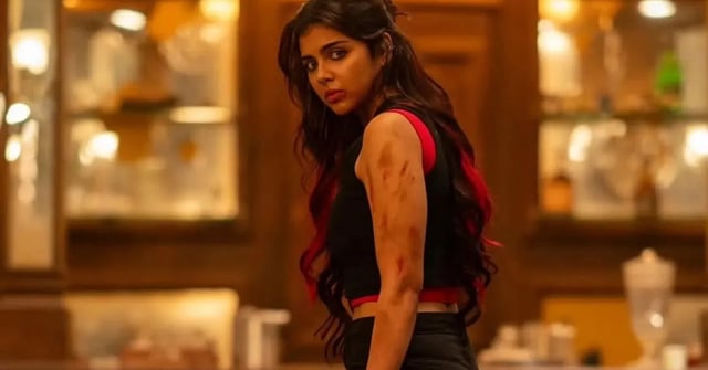 Kalyani Priyadarshan in a still from Lokah, holding a dagger in her hand.