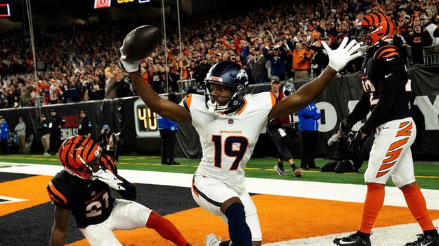 Denver Broncos wide receiver Marvin Mims Jr. (19) reacts to scoring a touchdown as Cincinnati Bengals cornerback Mike Hilton (21) and Cincinnati Bengals safety Geno Stone (22) look on with 8 seconds left in the fourth quarter of the NFL game at Paycor Stadium in Cincinnati on Saturday, Dec. 28, 2024.