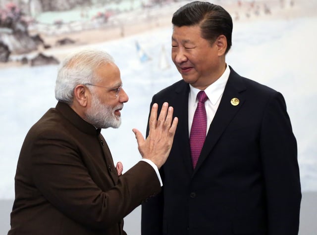 Indian Prime Minister Narendra Modi, left, greets Chinese President Xi Jinping before a dinner in Xiamen, China on September 4, 2017.
