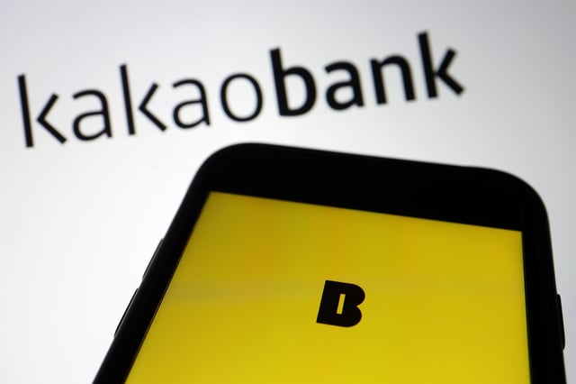 The Kakao Bank app is seen on a mobile phone screen displayed in front of the South Korean digital lender's logo in this illustration picture taken August 6, 2021. REUTERS/Florence Lo/Illustration