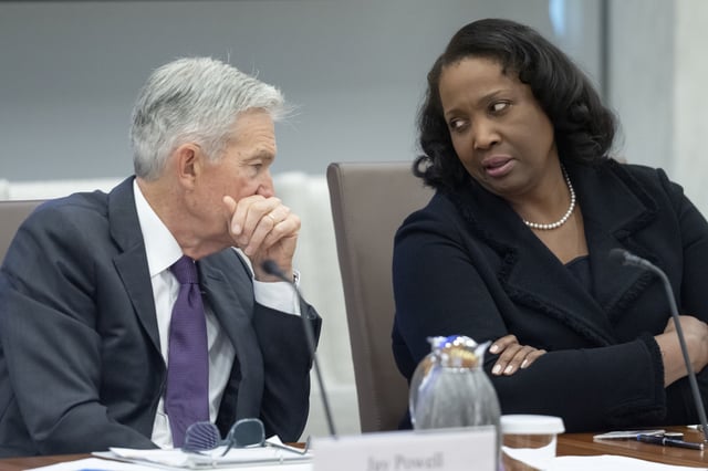 FILE - Federal Reserve Chairman Jerome Powell, left, talks with Board of Governors member Lisa Cook, right, during an open meeting of the Board of Governors at the Federal Reserve, June 25, 2025, in Washington. (AP Photo/Mark Schiefelbein, File)