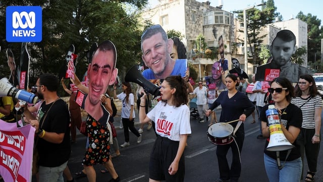 A group of people holding megaphones while holding cardboard cutouts of people.