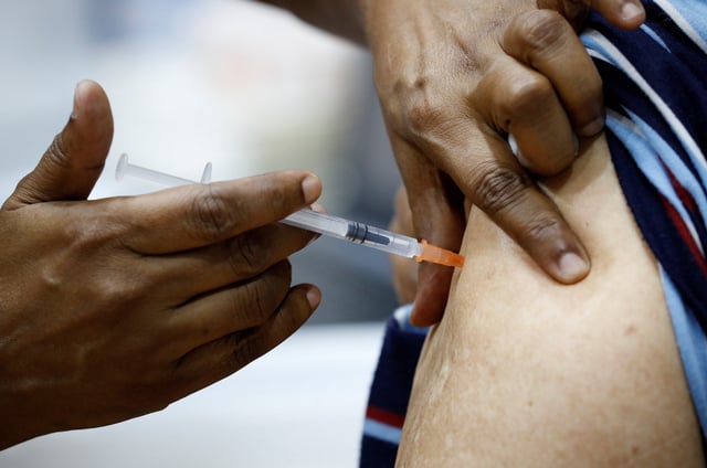 A man receives a vaccination at a medical centre in Singapore March 8, 2021. REUTERS/Edgar Su/File Photo