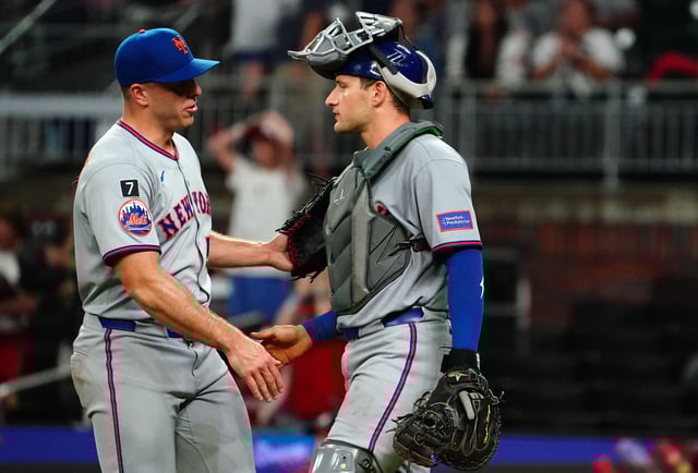 ATLANTA, GEORGIA - AUGUST 22: Ryan Helsley #56 of the New York Mets celebrates with catcher Hayden Senger #30 of the New York Mets after their 12-7 win over the Atlanta Braves at Truist Park on August 22, 2025 in Atlanta, Georgia.