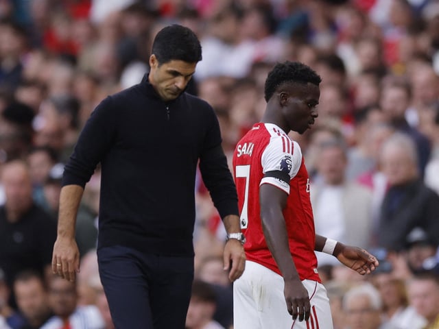 Soccer Football - Premier League - Arsenal v Leeds United - Emirates Stadium, London, Britain - August 23, 2025 Arsenal's Bukayo Saka with manager Mikel Arteta after being substituted Action Images via Reuters/Andrew Couldridge/File Photo