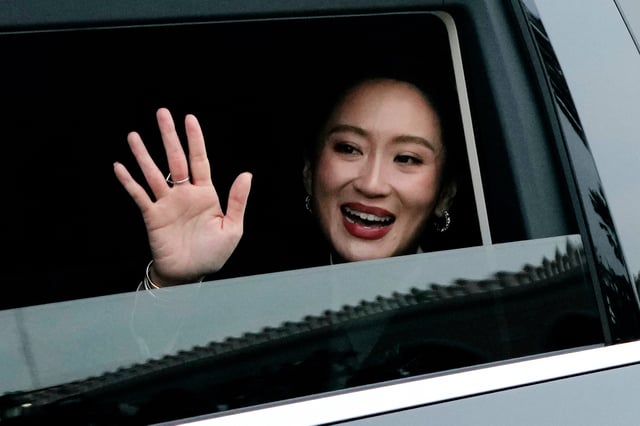 Thailand's suspended Prime Minister Paetongtarn Shinawatra waves as she leaves the Government House after being dismissed from her position, in Bangkok, Thailand, Friday, Aug. 29, 2025. (AP Photo/Sakchai Lalit)