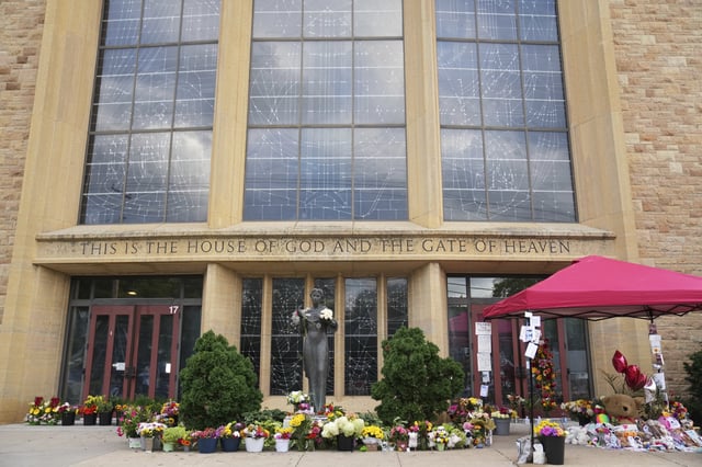 Items line a memorial at Annunciation Catholic Church after Wednesday's school shooting, Thursday, Aug. 28, 2025, in Minneapolis. (AP Photo/Abbie Parr)
