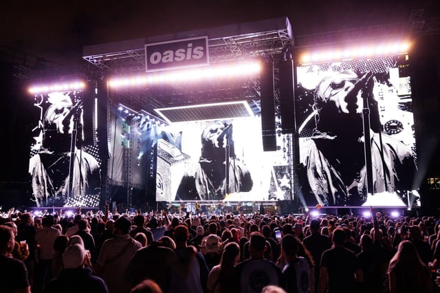 Fans watch Oasis perform at Soldier Field on Aug. 28, 2025, in Chicago. Chicago is one of three cities in the United States for the British band’s world tour and one of just five in North America. (Armando L. Sanchez/Chicago Tribune)