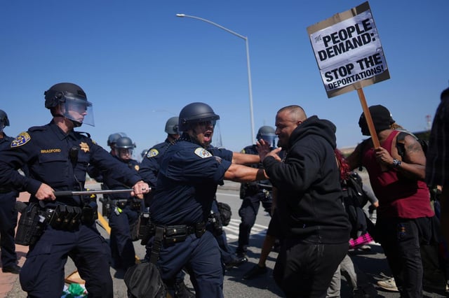 California Highway Patrol officers clash with protesters in June in Los Angeles. (ERIC THAYER/AP FILE)