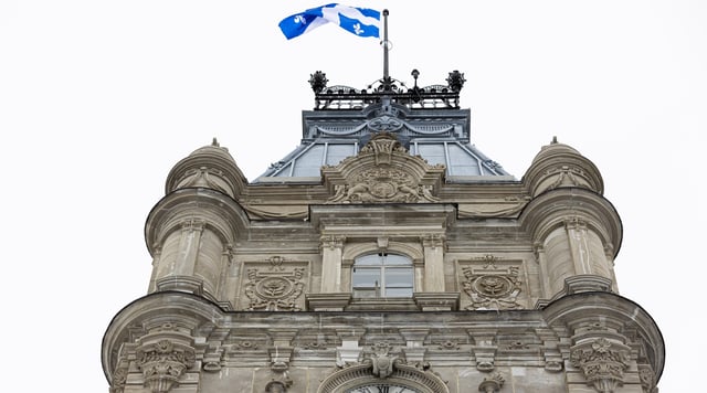 The Quebec flag flies over The Parliament Building of Quebec, home to the National Assembly of Quebec, in Quebec City Monday, February 20, 2023. THE CANADIAN PRESS IMAGES/Francis Vachon