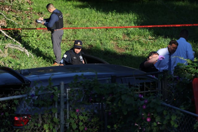 Chicago police look over a vehicle as they investigate the scene of a police involved shooting near W. 58th Street and Shields Avenue in Chicago, Aug. 27, 2025. (Antonio Perez/Chicago Tribune)