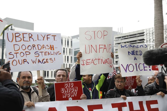 Members rally during a California Gig Workers Union demonstration on Oct.12, 2022 in San Francisco. Uber, Lyft and state leaders announced support Friday for a bill to let ride-hail drivers unionize.