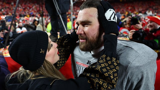 Jan 26, 2025; Kansas City, MO, USA; Recording artist Taylor Swift and Kansas City Chiefs tight end Travis Kelce (87) react after the AFC Championship game against the Buffalo Bills at GEHA Field at Arrowhead Stadium. Mandatory Credit: Mark J. Rebilas-Imagn Images