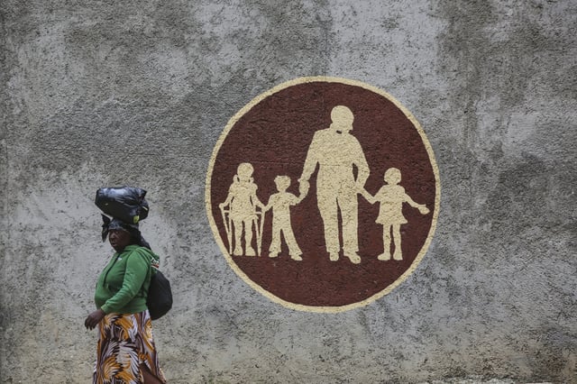 A woman walks past the Saint-Helene orphanage in the Kenscoff neighborhood of Port-au-Prince, Haiti, Monday, Aug. 4, 2025. (AP Photo/Odelyn Joseph)