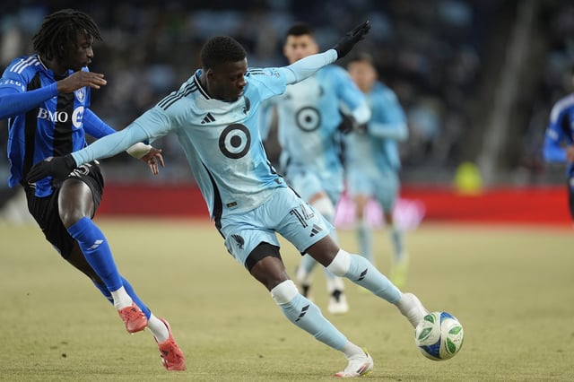 Minnesota United forward Tani Oluwaseyi (14) controls the ball as CF Montreal midfielder Ousman Jabang, left, defends during the second half of an MLS soccer match in St. Paul, Minn., Saturday, March 1, 2025. (AP Photo/Abbie Parr)