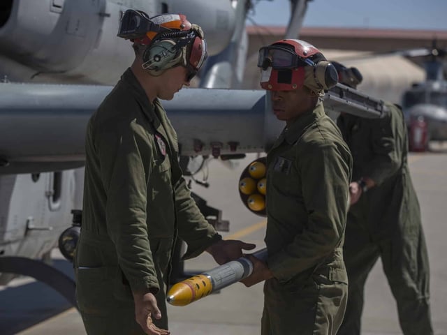 U.S. Marines assigned to Marine Aviation Weapons and Tactics Squadron 1 load a 2.75-inch rocket configured with Advanced Precision Kill Weapon System II onto an AH-1Z Viper. (U.S. Marine Corps photo by Lance Cpl. Ashley McLaughlin/Released)
