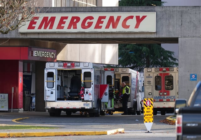 A paramedic is seen outside ambulances parked at the entrance to the emergency department at Richmond General Hospital, in Richmond, B.C., Sunday, Nov. 27, 2022. THE CANADIAN PRESS/Darryl Dyck
