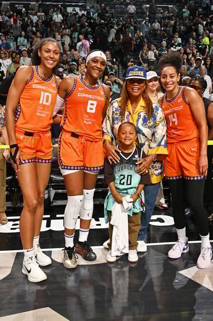 From L to R: Olivia Nelson-Ododa, Aaliyah Edwards, Bria Hartley enjoy a photo opp with Queen Latifah and her son Rebel. 
