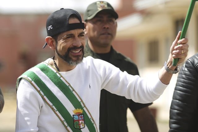 Opposition leader Luis Fernando Camacho, the suspended governor of Santa Cruz, wears a sash and flag of his department as he is released from jail and allowed house arrest after almost three years in pretrial detention for his involvement in violent unrest that led to the 2019 ouster of then-President Evo Morales, in La Paz, Bolivia, Friday, Aug. 29, 2025. (AP Photo/Gaston Brito)