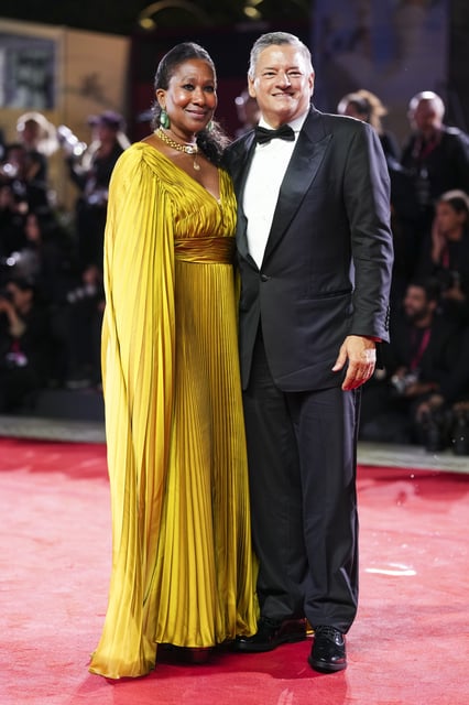 Nicole Avant in a pleated, metallic gown, left, and Ted Sarandos in a classic black tux.