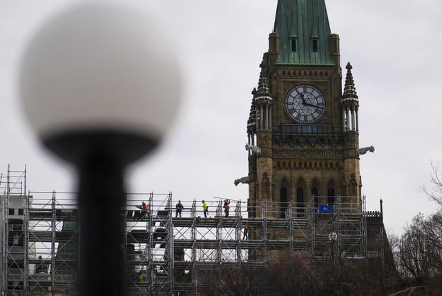 Construction workers build scaffolding on Parliament Hill in Ottawa  on Thursday, March 20, 2025. THE CANADIAN PRESS/Sean Kilpatrick