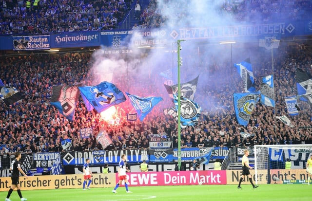 Fans light flares during the Bundesliga match between Hamburg and St Pauli on Friday.