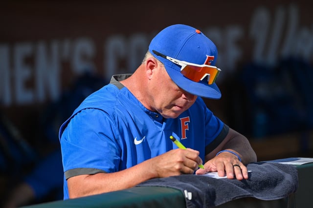 Jun 24, 2023; Omaha, NE, USA;  Florida Gators head coach Kevin O'Sullivan takes notes before the game against the LSU Tigers at Charles Schwab Field in Omaha. Mandatory Credit: Steven Branscombe-USA TODAY Sports/File Photo