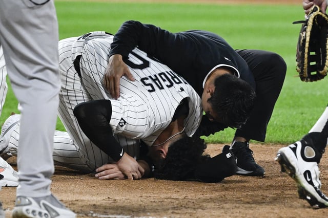 Aug 28, 2025; Chicago, Illinois, USA;  Chicago White Sox first baseman Miguel Vargas (20) is examined by a team member after being injured during the fifth inning against the New York Yankees at Rate Field. Mandatory Credit: Matt Marton-Imagn Images