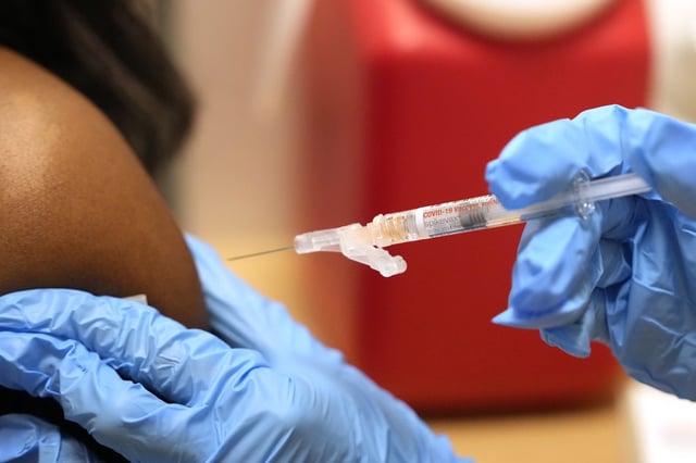 A pharmacist gives a COVID-19 vaccine in Cypress, Texas in 2023.