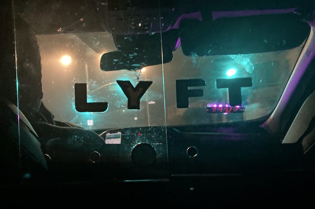 FILE - A Lyft sign is displayed in a driver's car in San Francisco, April 27, 2023. (AP Photo/Jeff Chiu, File)