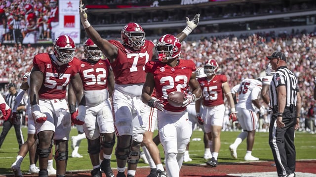 Oct 12, 2024; Tuscaloosa, Alabama, USA; Alabama Crimson Tide offensive lineman Jaeden Roberts (77) and his teammates react after Alabama Crimson Tide running back Justice Haynes (22) scores a touchdown agains the South Carolina Gamecocks during the second quarter at Bryant-Denny Stadium. Mandatory Credit: Will McLelland-Imagn Images