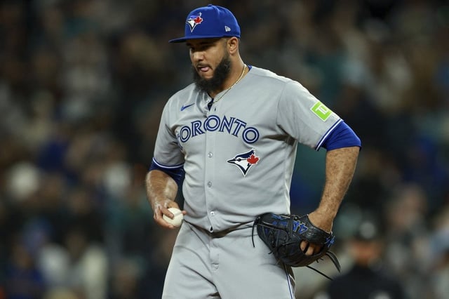 Toronto Blue Jays relief pitcher Yimi Garcia reacts after throwing a wild pitch during the eighth inning of a baseball game against the Seattle Mariners, Friday, May 9, 2025, in Seattle. (AP Photo/Rio Giancarlo)