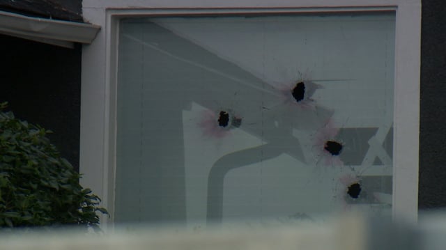What appear to be bullet holes could be seen in the window of a home in the 500 block of Crescent Road in Calgary.
