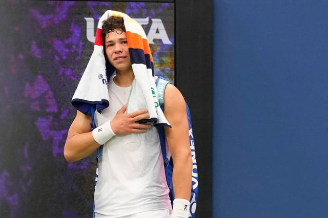 Ben Shelton, of the United States, reacts as he walks off the court after retiring against Adrian Mannarino, of France, during the third round of the U.S. Open tennis championships, Friday, Aug. 29, 2025, in New York. (AP Photo/Kirsty Wigglesworth)