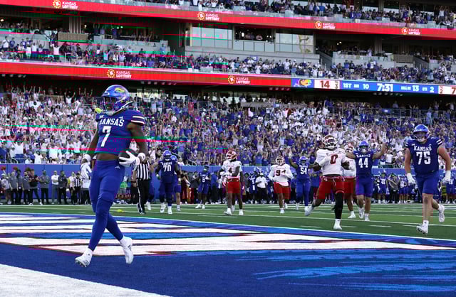 Cam Pickett #7 of the Kansas Jayhawks carries the ball into the end zone for a touchdown during the first half of the game against the Fresno State Bulldogs at David Booth Kansas Memorial Stadium on August 23, 2025 in Lawrence, Kansas.