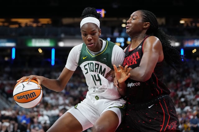INDIANAPOLIS, INDIANA - AUGUST 26: Dominique Malonga #14 of the Seattle Storm dribbles the ball while being guarded by Aliyah Boston #7 of the Indiana Fever in the third quarter at Gainbridge Fieldhouse on August 26, 2025 in Indianapolis, Indiana.