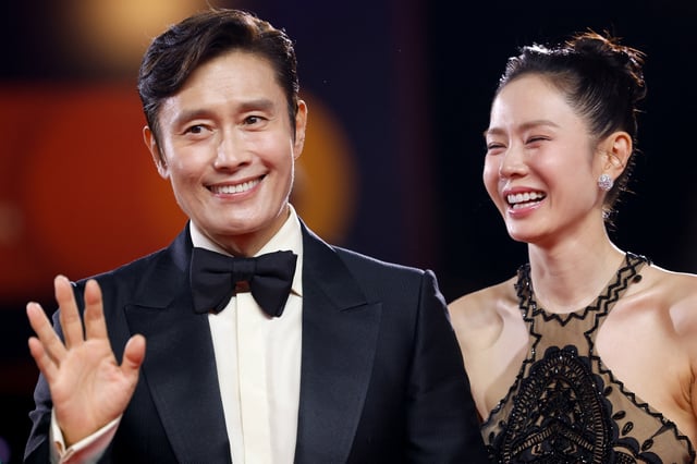 Cast member Son Ye-jin reacts next to Lee Byung-hun on the red carpet for the screening of the movie "No Other Choice" in competition, at the 82nd Venice International Film Festival, Venice, Italy, August 29, 2025. REUTERS/Remo Casilli