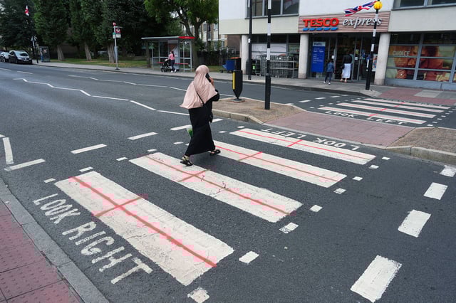 The debate plays out at street level. A pedestrian crossing in London's Isle of Dogs has been painted to resemble the English flag.