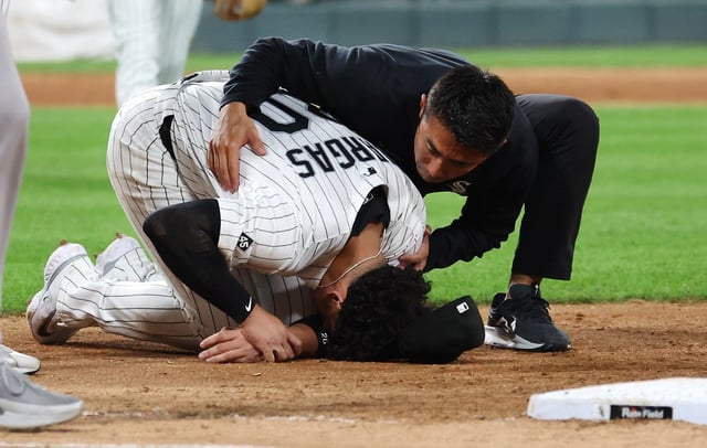 Chicago White Sox first baseman Miguel Vargas receives medical attention after suffering an injury in the fifth inning of a game against the New York Yankees at Rate Field in Chicago on Aug. 28, 2025.  (Chris Sweda/Chicago Tribune)