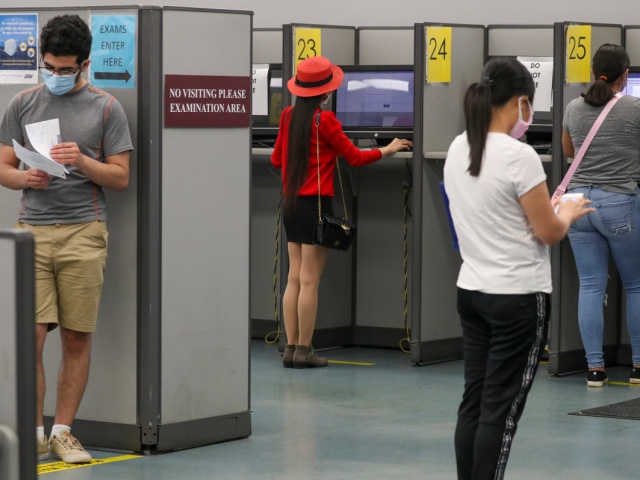 Clients observe social distancing while giving written driving test at DMV on Thursday, Aug. 13, 2020 in Westminster, CA. (Irfan Khan / Los Angeles Times via Getty Images)