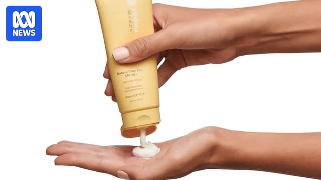 A hand squeezes Endota natural zinc sunscreen from a tube.