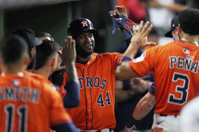 Astros designated hitter Yordan Alvarez (44) celebrates in the dugout after scoring on Carlos Correa's hit for the game's first run during the seventh inning Friday against the Angels.
