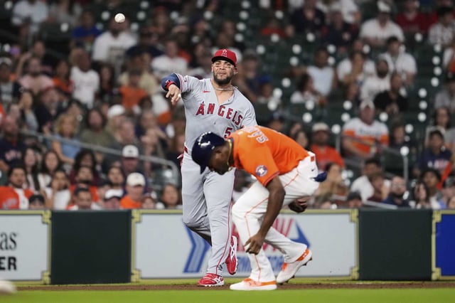 Los Angeles Angels third baseman Yoan Moncada (5) throws to first over Houston Astros' Jesus Sanchez during the second inning of a baseball game in Houston, Friday, Aug. 29, 2025. (AP Photo/Ashley Landis)